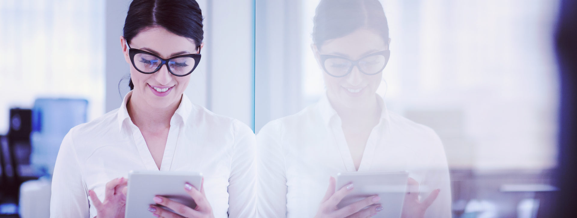 Pretty Businesswoman Using Tablet In front of startup Office Interior